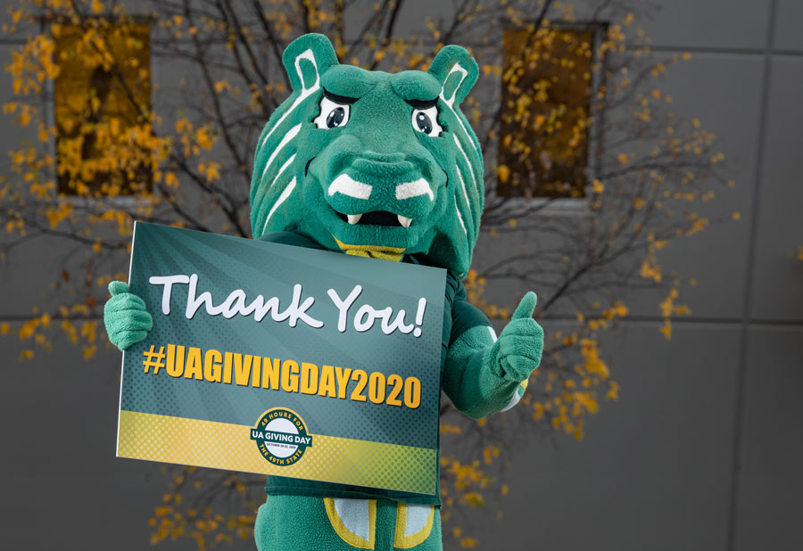 UAA Mascot holding UA Giving Day 2020 sign