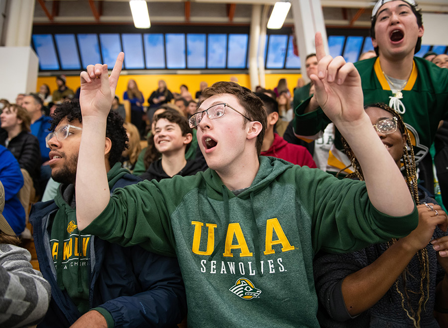 UAA students cheer and roar on their Seawolves hockey team during a game