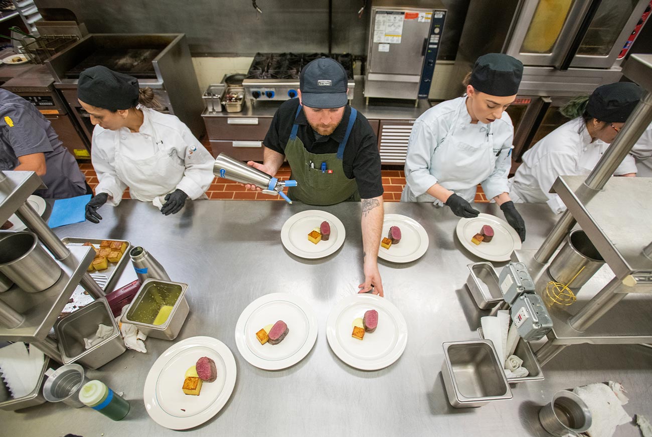top view of culinary students working alongside Alaska’s top chefs during the 2023 Celebrity Chef Invitational